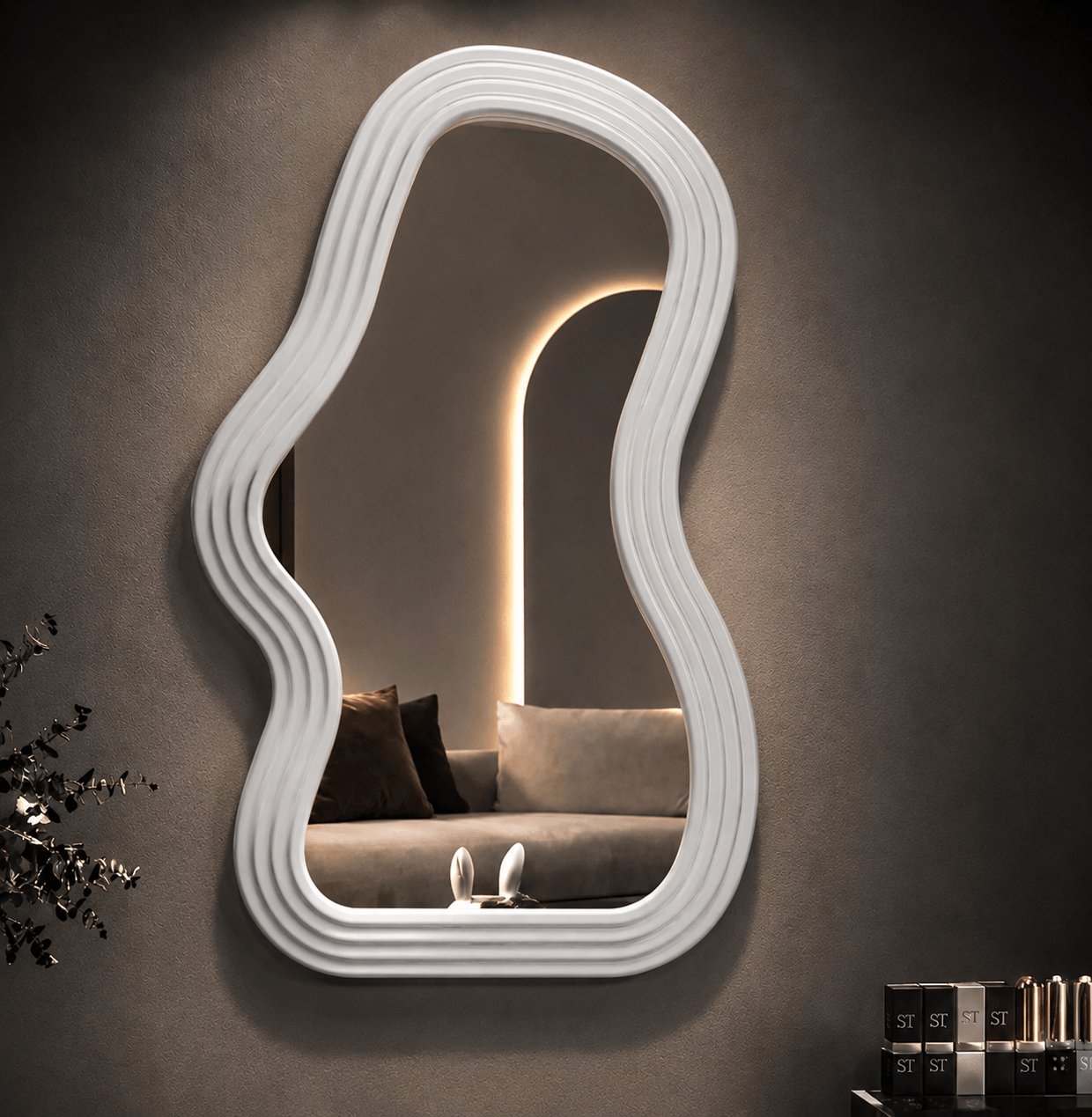 Decorative wavy wall mirror in white, enhancing modern decor in a stylish living space.
