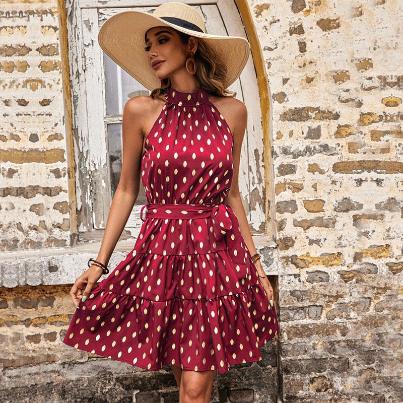 Golden Hour burgundy wine halter mini dress with metallic gold polka dots, self-tie waist belt and tiered A-line skirt.